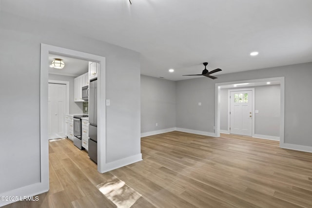 unfurnished living room featuring a ceiling fan, baseboards, recessed lighting, and light wood-style flooring
