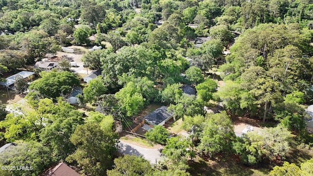 birds eye view of property featuring a view of trees