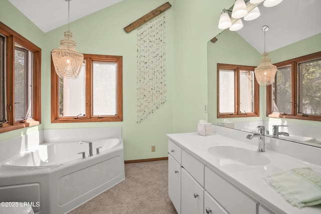 bathroom with vanity, a garden tub, baseboards, high vaulted ceiling, and a chandelier