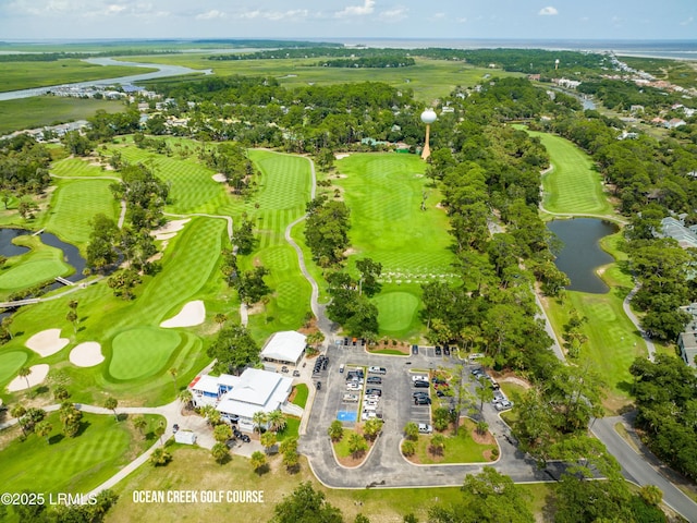 birds eye view of property with a water view and view of golf course