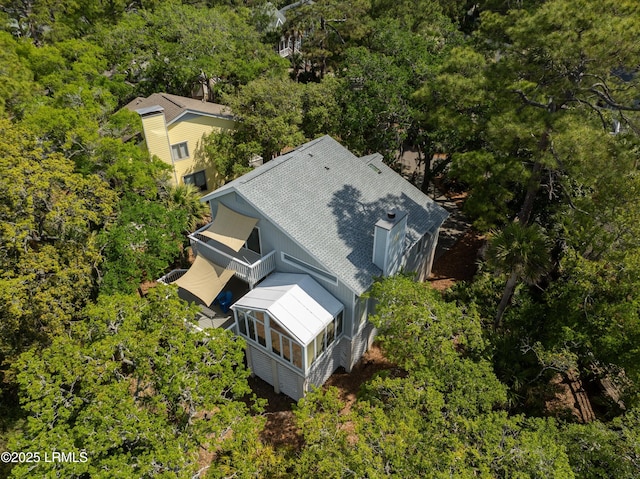 aerial view featuring a wooded view