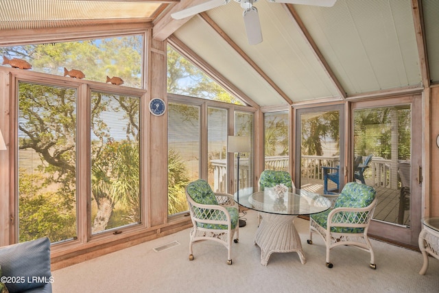 sunroom with visible vents, ceiling fan, and beam ceiling