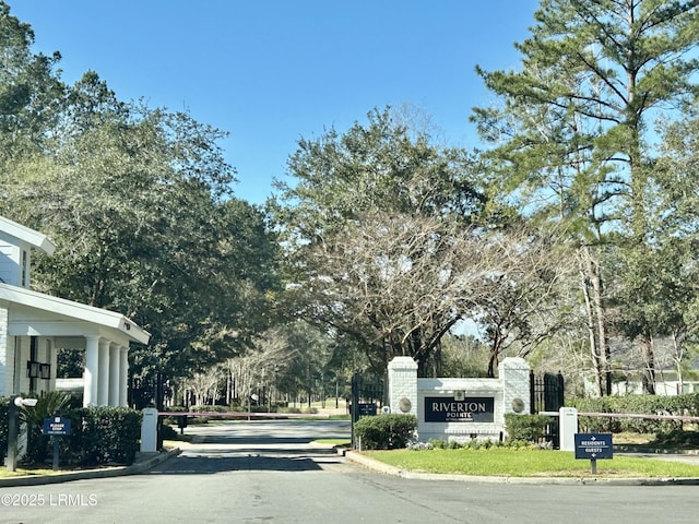 view of road featuring curbs and a gated entry