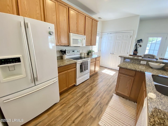 15 6th Ave, Bluffton, SC 29910 - kitchen featuring white appliances, light wood-style floors, and light stone countertops