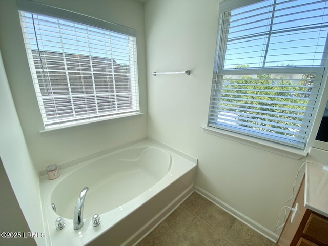 15 6th Ave, Bluffton, SC 29910 - bathroom with healthy amount of natural light, a bath, baseboards, and tile patterned flooring
