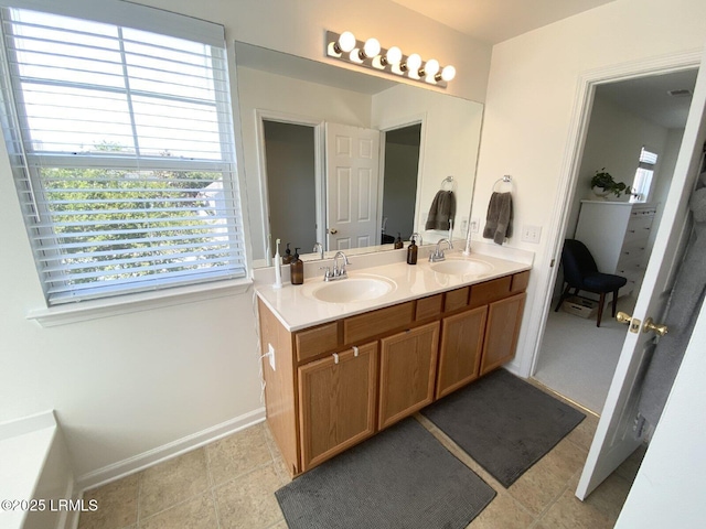15 6th Ave, Bluffton, SC 29910 - full bathroom featuring plenty of natural light, double vanity, baseboards, and tile patterned floors