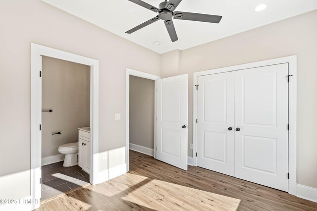 100 Battery Creek Club Dr, Beaufort, SC 29902 - unfurnished bedroom with wood finished floors, connected bathroom, a closet, baseboards, and ceiling fan