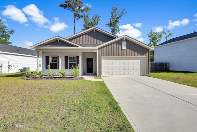 171 Great Bend Dr, Beaufort, SC 29906 - view of front facade with a porch, concrete driveway, fence, an attached garage, and a front yard