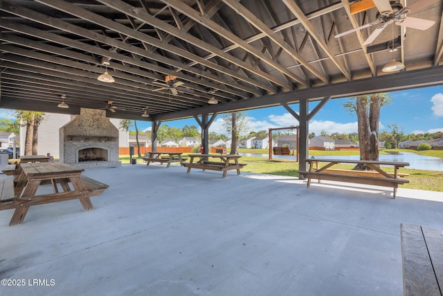 171 Great Bend Dr, Beaufort, SC 29906 - view of patio featuring an outdoor stone fireplace, a ceiling fan, a water view, and a residential view