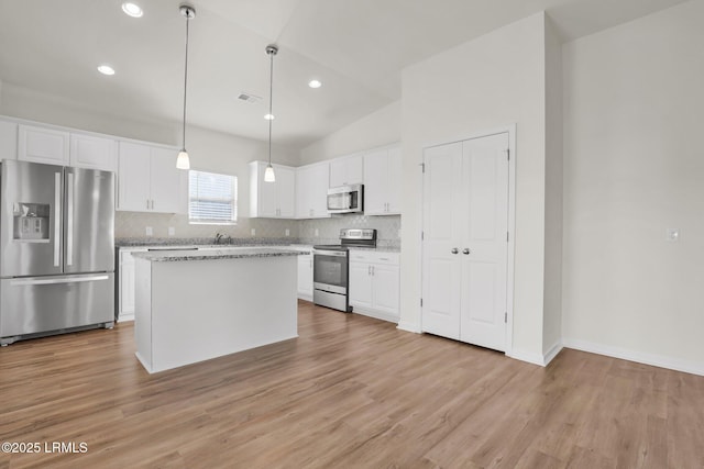 171 Great Bend Dr, Beaufort, SC 29906 - kitchen featuring white cabinets, light wood finished floors, stainless steel appliances, a center island, and decorative backsplash