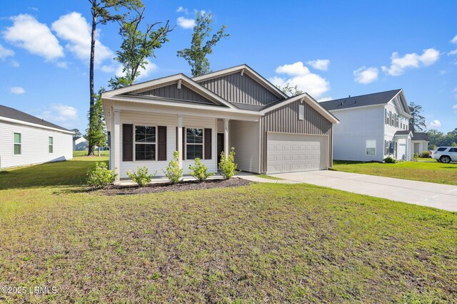 171 Great Bend Dr, Beaufort, SC 29906 - view of front of house with concrete driveway, a front yard, board and batten siding, and a garage