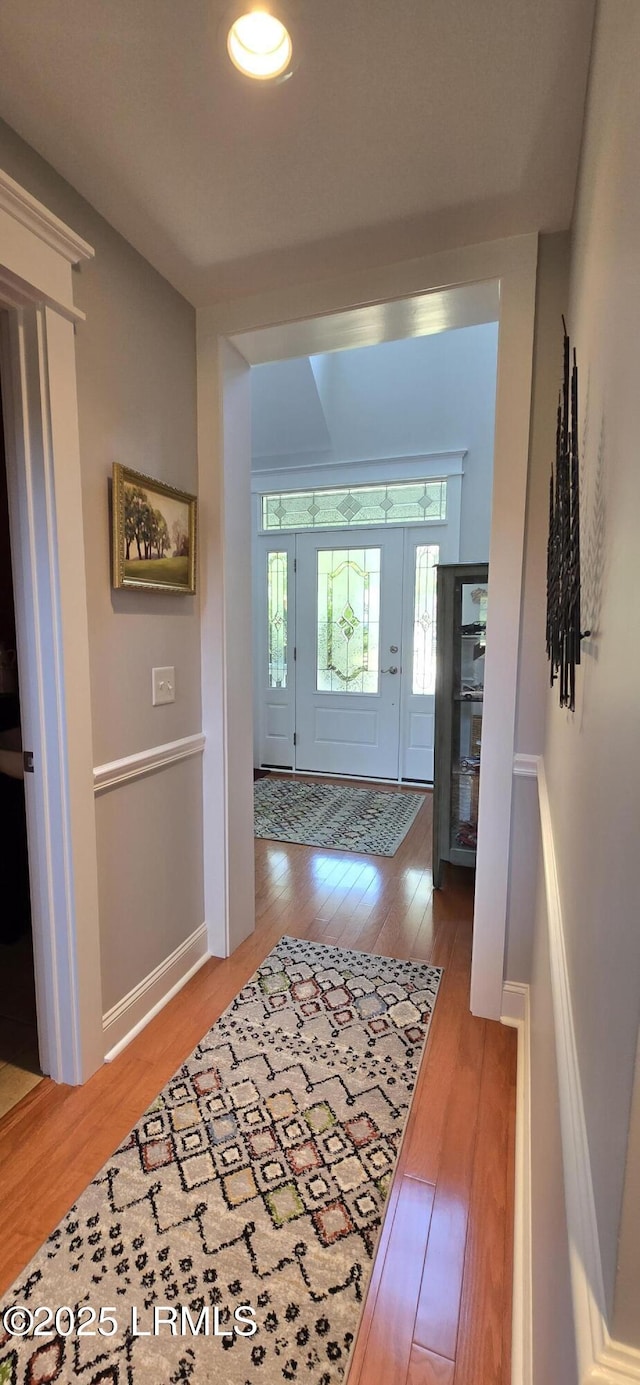 entrance foyer featuring hardwood / wood-style floors and baseboards