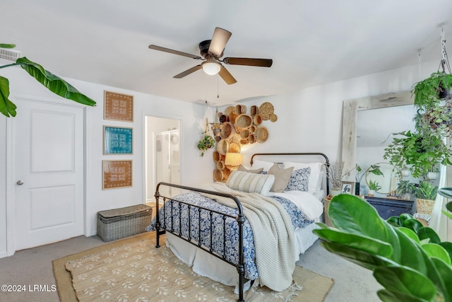 carpeted bedroom featuring ceiling fan and connected bathroom