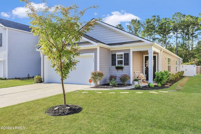 view of front of property with an attached garage, fence, a front lawn, and concrete driveway