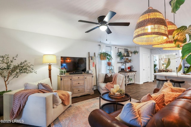 living room with hardwood / wood-style floors and ceiling fan with notable chandelier