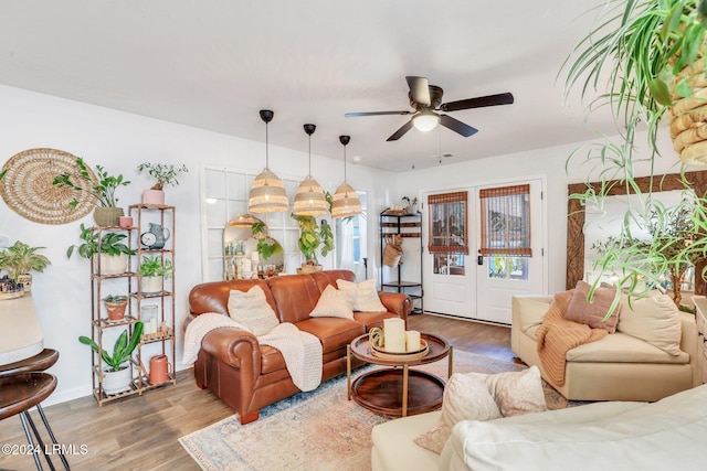 living room with hardwood / wood-style flooring, ceiling fan, and french doors