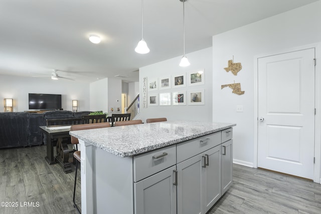 74 Keowee Ln, Beaufort, SC 29906 - kitchen featuring ceiling fan, dark wood finished floors, a kitchen island, pendant lighting, and a breakfast bar