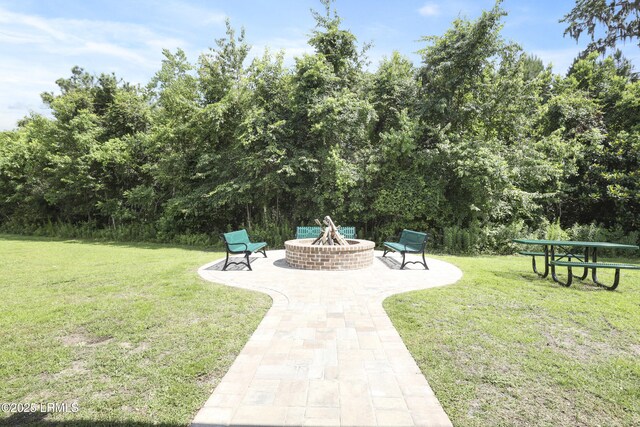 74 Keowee Ln, Beaufort, SC 29906 - view of grassy yard featuring a fire pit and a patio