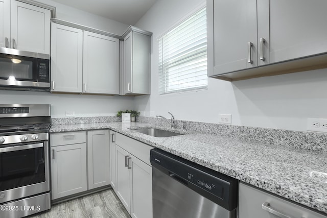 74 Keowee Ln, Beaufort, SC 29906 - kitchen featuring stainless steel appliances, gray cabinets, light wood-type flooring, and light stone countertops