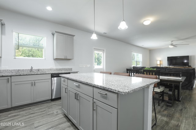 74 Keowee Ln, Beaufort, SC 29906 - kitchen with gray cabinetry, stainless steel dishwasher, wood finished floors, and a center island