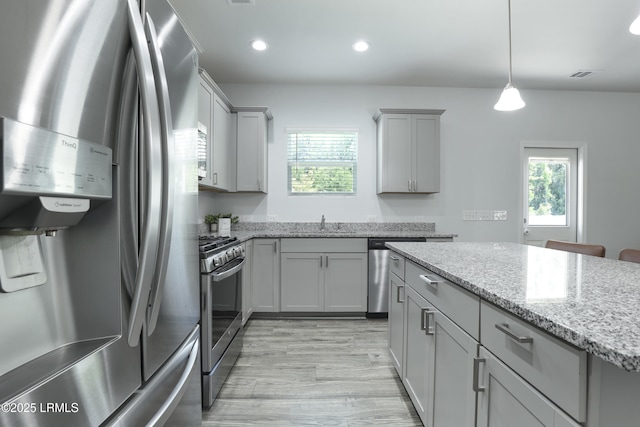 74 Keowee Ln, Beaufort, SC 29906 - kitchen with appliances with stainless steel finishes, gray cabinets, plenty of natural light, light stone countertops, and recessed lighting