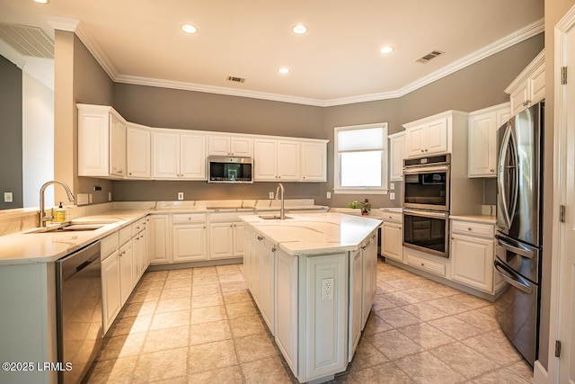 1348 Rowland Dr, Saint Helena Island, SC 29920 - kitchen with white cabinetry, sink, stainless steel appliances, and an island with sink