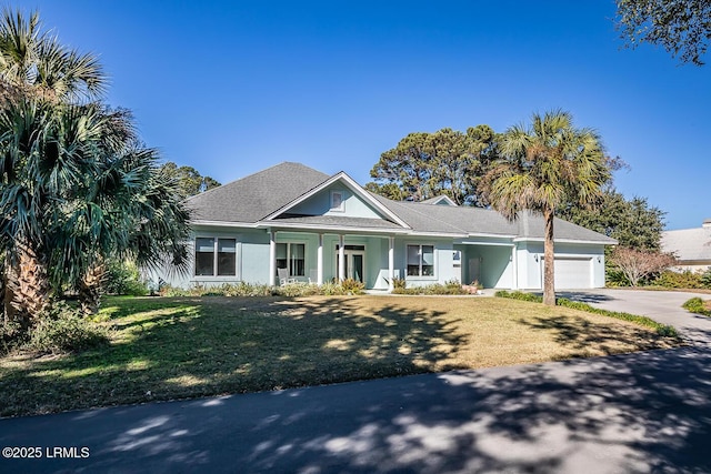 view of front of property with a garage and a front lawn