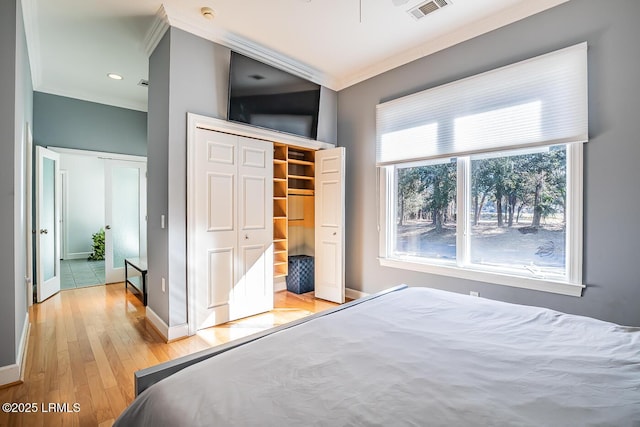 1348 Rowland Dr, Saint Helena Island, SC 29920 - bedroom with crown molding, light hardwood / wood-style floors, and a closet
