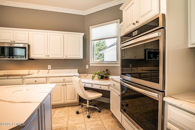 1348 Rowland Dr, Saint Helena Island, SC 29920 - kitchen with crown molding, light stone counters, light tile patterned floors, stainless steel appliances, and white cabinets