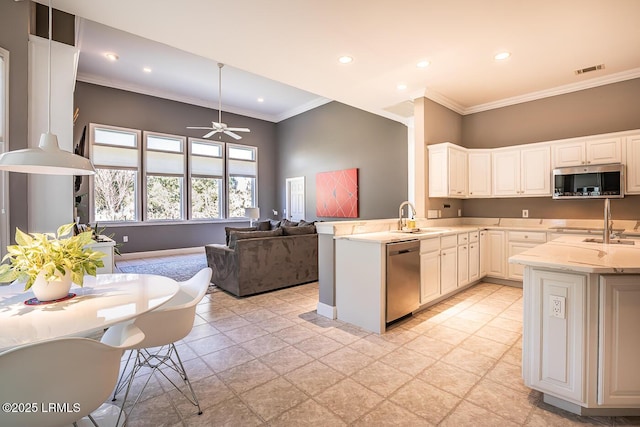 1348 Rowland Dr, Saint Helena Island, SC 29920 - kitchen featuring appliances with stainless steel finishes, kitchen peninsula, and white cabinets