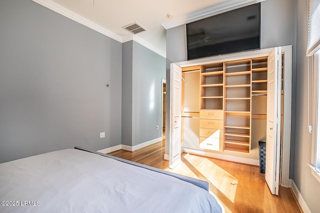 1348 Rowland Dr, Saint Helena Island, SC 29920 - unfurnished bedroom with crown molding, light hardwood / wood-style floors, and a closet