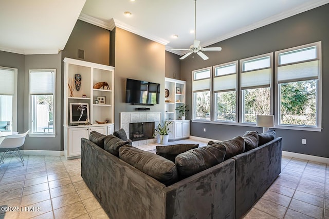 1348 Rowland Dr, Saint Helena Island, SC 29920 - tiled living room featuring crown molding, ceiling fan, and a tiled fireplace