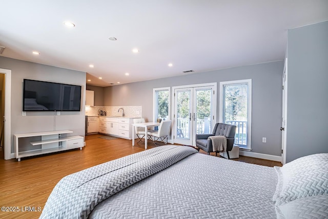 1348 Rowland Dr, Saint Helena Island, SC 29920 - bedroom with french doors, hardwood / wood-style flooring, sink, and access to outside