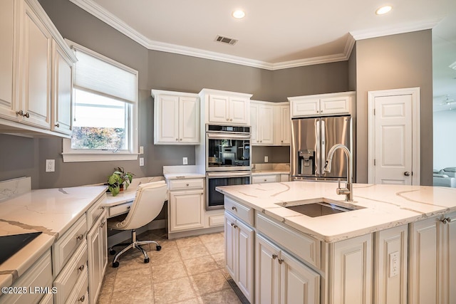 1348 Rowland Dr, Saint Helena Island, SC 29920 - kitchen featuring sink, crown molding, appliances with stainless steel finishes, light stone countertops, and a center island with sink