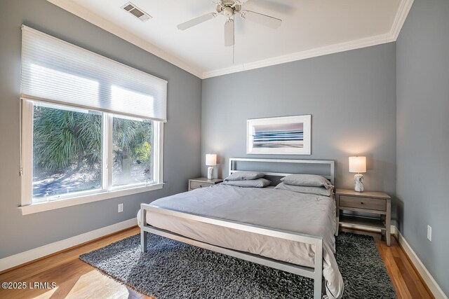1348 Rowland Dr, Saint Helena Island, SC 29920 - bedroom with wood-type flooring, crown molding, and ceiling fan