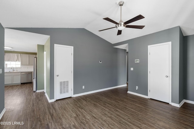 interior space with dark wood-type flooring, ceiling fan, vaulted ceiling, and sink