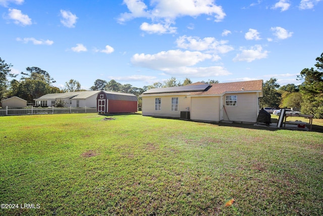 view of yard featuring central AC unit and a storage unit