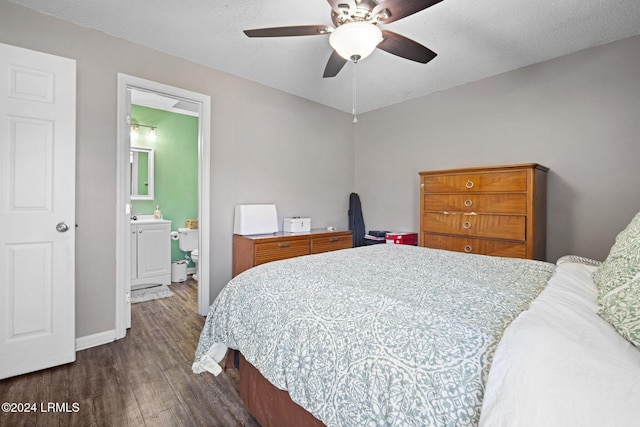 bedroom featuring ceiling fan, dark hardwood / wood-style floors, a textured ceiling, and ensuite bath