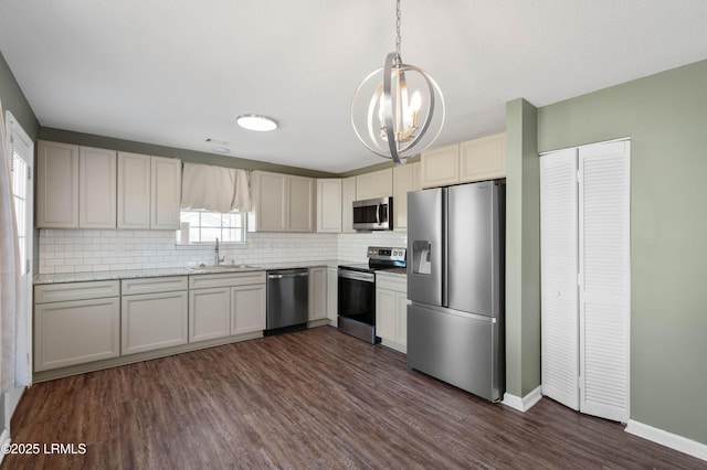 kitchen featuring sink, decorative light fixtures, dark hardwood / wood-style flooring, stainless steel appliances, and decorative backsplash