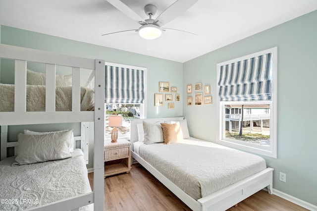 108 Harbor Dr N, Harbor Island, SC 29920 - bedroom with multiple windows, wood finished floors, ceiling fan, and baseboards