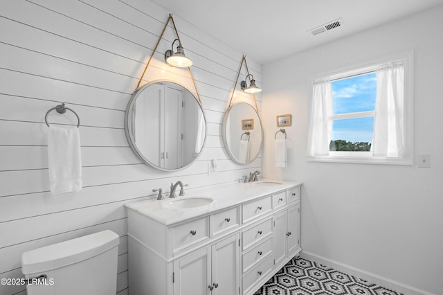 108 Harbor Dr N, Harbor Island, SC 29920 - full bathroom featuring toilet, double vanity, baseboards, and tile patterned floors