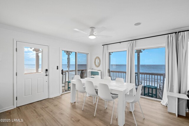 108 Harbor Dr N, Harbor Island, SC 29920 - dining room with a water view, light wood-style floors, ornamental molding, and a ceiling fan