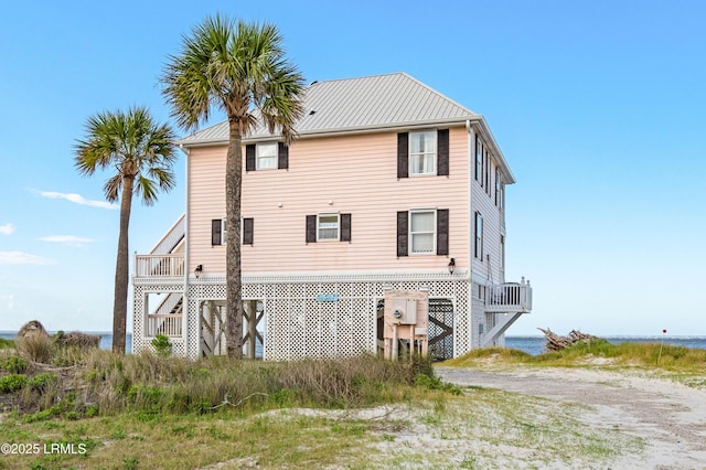 108 Harbor Dr N, Harbor Island, SC 29920 - rear view of house featuring a water view, metal roof, and driveway