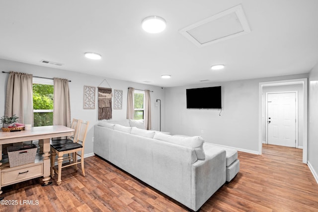 7058 Roseida Rd, Beaufort, SC 29906 - living room featuring wood finished floors, plenty of natural light, and attic access