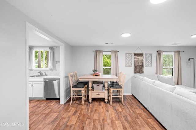 7058 Roseida Rd, Beaufort, SC 29906 - dining area with light wood-style floors and plenty of natural light