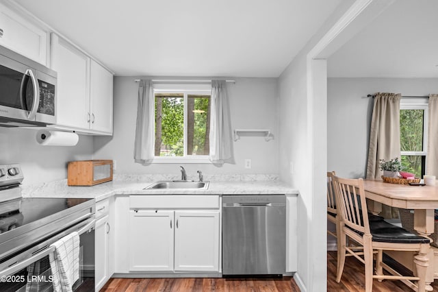 7058 Roseida Rd, Beaufort, SC 29906 - kitchen featuring appliances with stainless steel finishes, white cabinets, and wood finished floors