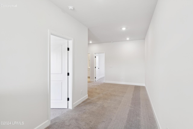 unfurnished room featuring light carpet