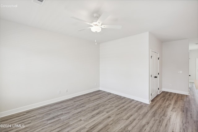 spare room with ceiling fan and light hardwood / wood-style flooring