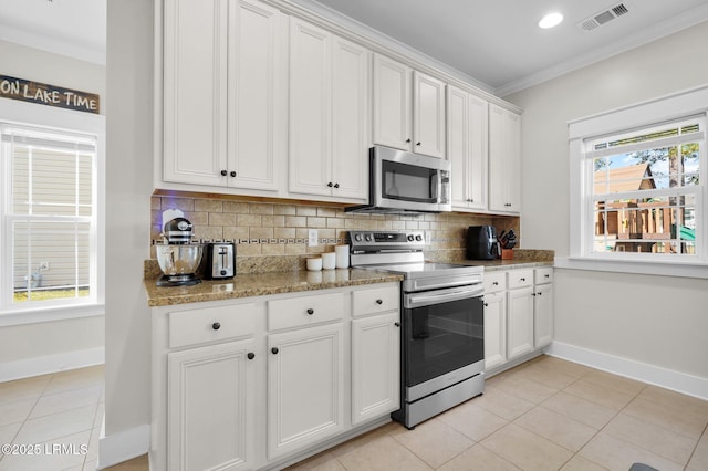 kitchen with tasteful backsplash, visible vents, crown molding, appliances with stainless steel finishes, and light tile patterned flooring