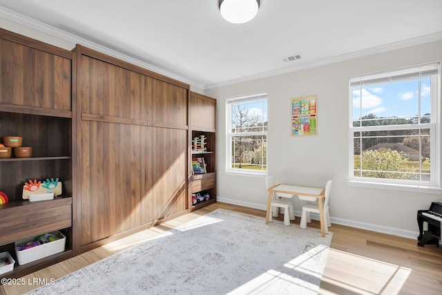 sitting room featuring a wealth of natural light, visible vents, baseboards, and light wood-style floors